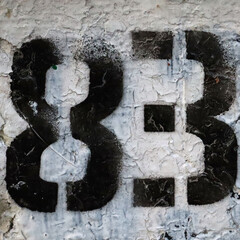 Black stenciled numbers 83 on a textured white surface