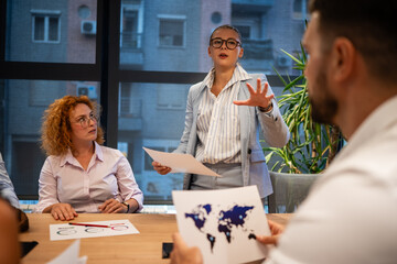 Fototapeta premium Businesswoman leading confident team presentation in office