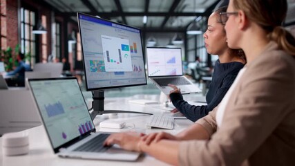 Analyzing Financial Performance: Female Analyst Monitors Data Dashboard - Powered by Adobe