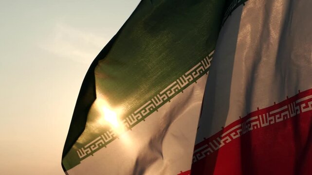 Waving Iran national flag with sunlight shining through fabric texture, symbolizing patriotism, national identity, culture, and political concept, ideal for global news, diplomacy