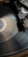 Grooves on a black vinyl record spinning on a turntable, capturing music's analog magic,  audio,  music