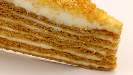 Fototapeta premium Close-up of a delicious layered honey cake slice