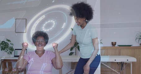 Older woman in pink shirt performing arm curls in therapy, therapist supporting pink weights and AR