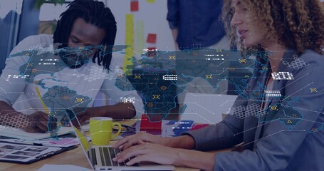 Collaborating team in blazers sketching and typing in creative office, with laptop and AR map