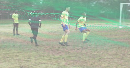 Running male player wearing yellow kit and cleats on worn pitch, showing soccer goal, green overlay