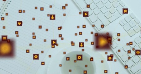 Floating network of orange social icons connecting over workspace, showing keyboard, notebook, cup