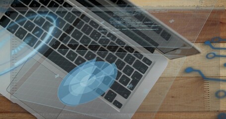 Aluminum laptop keyboard and trackpad showing holographic overlays on wood desk, notebook edge