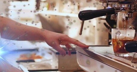 Steadying barista arm in short-sleeve shirt adjusting shot glass on coffee counter with portafilter