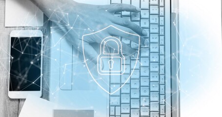 Typing right hand pressing laptop keys on wooden desk office, with smartphone and security overlays