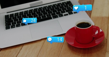 Showing red coffee cup on saucer resting on wooden desk with laptop alerts 24 or 14 or 1, copy space