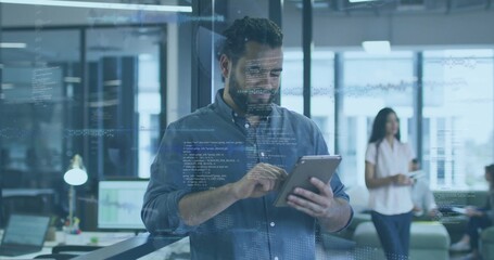 Tapping bearded man wearing blue shirt interacting with tablet at modern office, with data overlay