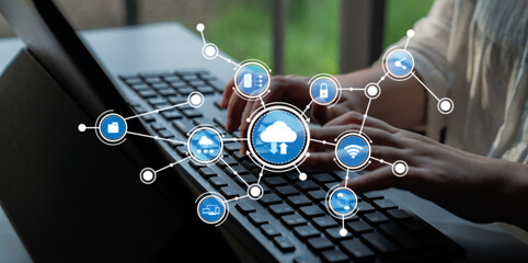 A person typing on a laptop keyboard, surrounded by various cloud computing icons symbolizing data management and network solutions in a modern workspace setting. Tessel