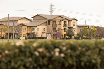 Trees frame dense housing and a street in a residential district of Chino, California, USA.