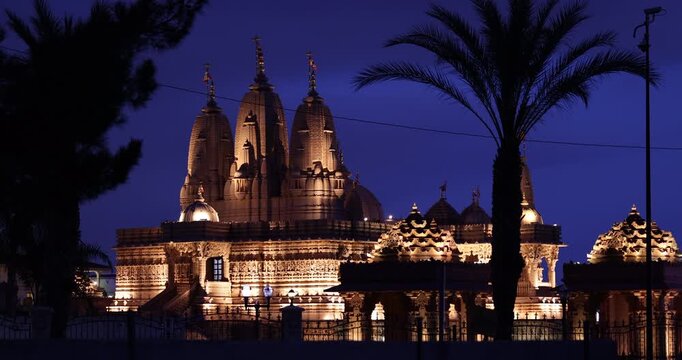 Chino Hills, California, USA - March 1, 2025: Artifical lights illuminate the Hindu temple towers of BAPS Shri Swaminarayan Mandir.