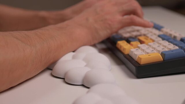 Keyboard setup showcase, Ergonomic mechanical keyboard display, Closeup of tactile switches on custom keyboard, Designer testing pastel keycaps with ergonomic wrist cushion setup