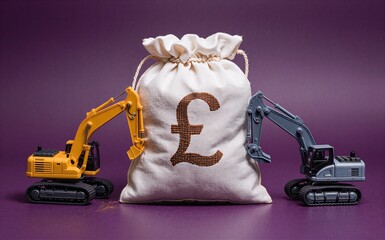 Two toy excavators flank a money bag marked with British pound symbol, representing construction investment.