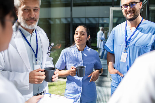 Doctors and nurses having coffee break outside hospital
