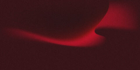 Abstract red glow on dark background with curved gradient lighting and grainy texture. © yun visual