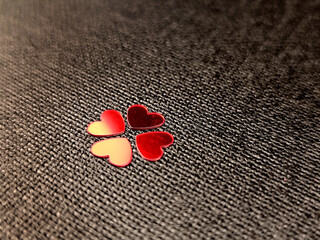 Lucky four leaf clover shape made of red metallic hearts