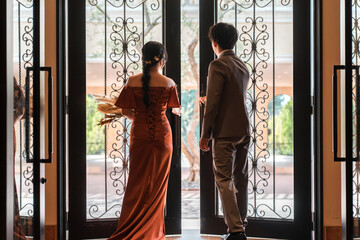 Wedding reception, after-party, bride and groom appearing in wedding color dresses, dressed-up...