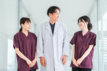 Medical workers in scrubs, medical staff, female nurses and male doctors in white coats