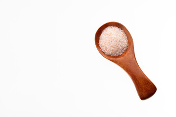 Spoon with fine grains of pink Himalayan salt - Fine crystals sprinkled.