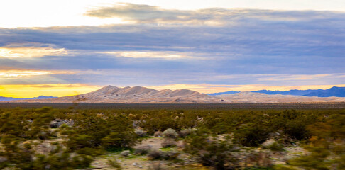 Sunset road through Mojave Desert mountain range