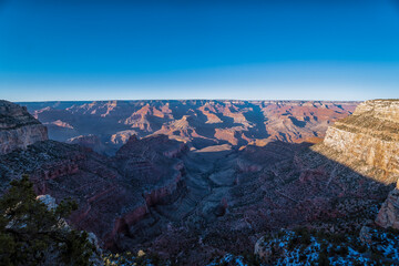 The sky is blue and the mountains are in the background. The mountains are very tall and the sky is very clear