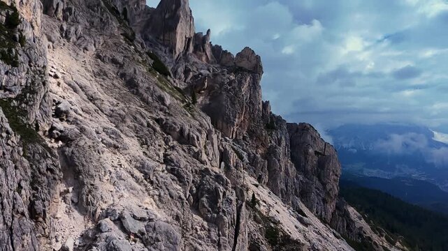Dolomies, Italy Steep Scree Slope Descending Into Clouded Alpine Valley, Mountain Rescue Team Rehearsing Descent And Ropework On Loose Gravel, Harsh Terrain And Exposed Rockface Create Tense