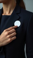 A confident businesswoman wearing a lapel pin in a professional setting