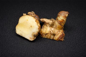Fresh Galangal Root Rhizome Isolated on Dark Background