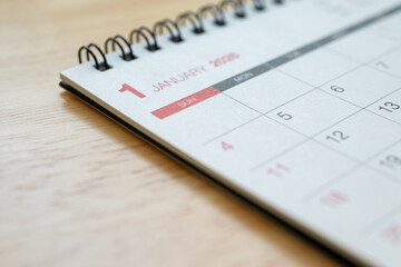 January 2026 calendar page on wooden desk for planning and new year goals