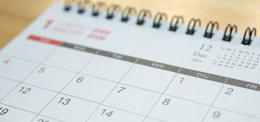 January 2026 calendar page on wooden desk for planning and new year goals