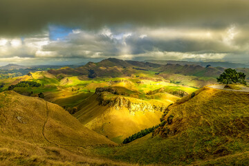 Dramatic light on the agricultural hills and valleys beneath Te Mata Peak