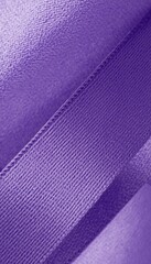 A close-up of a vibrant purple ribbon on a clean background, symbolizing awareness and solidarity.