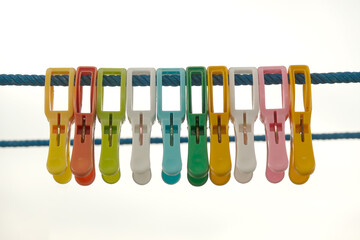 A Row of Colorful Plastic Clothespins on Clothesline