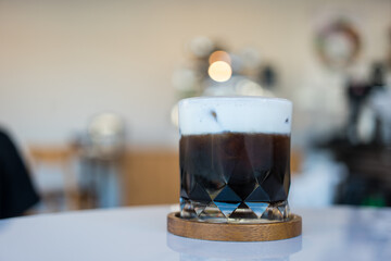 Iced black coffee combined with milk or cream in a glass for a tasty and refreshing break