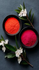 Red and Orange Powders in Black Bowls on Green Leaf