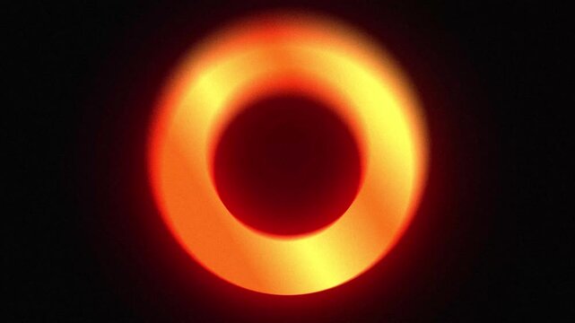 Abstract animated gradient ring with soft blur effect rotating smoothly, combined with subtle noise texture on a dark background, ideal for modern motion design and cinematic visuals.