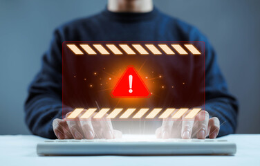 Cyber security alert concept with warning symbol over businessman using laptop. Digital data protection, online banking risk, hacking threat, malware, phishing attack and information security breach 