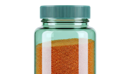 Green glass bottle filled with orange beads and light pink powder