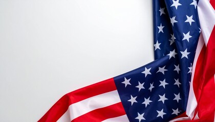 Fototapeta premium A close-up shot of a draped American flag with its red, white, and blue colors and stars, set against a clean white background, symbolizing patriotism and national pride.