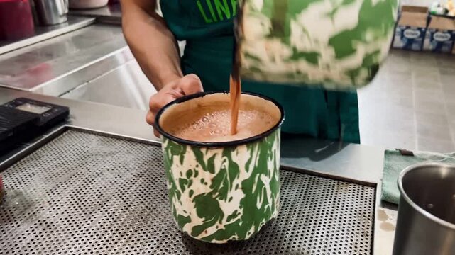 a man is making a drink by pulling