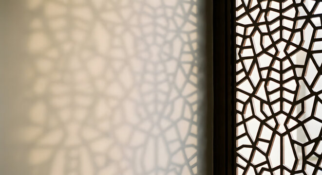 abstract geometric pattern of traditional islamic mashrabiya screen with decorative shadows cast on a wall in a warm interior setting showing architectural middle eastern design