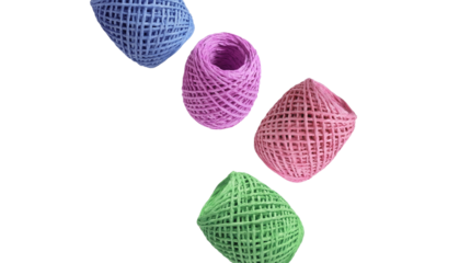 four colorful spools of twine arranged in a scattered pattern against a transparent background, shot in a studio for commercial use.