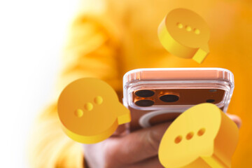 Man hand holding modern smartphone with floating chat message icons on white background. Concept of social media communication, online messaging, mobile app, digital interaction and user engagement.