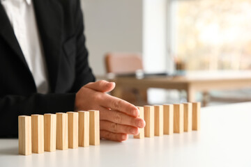 Female mediator separating blocks at table in office, closeup