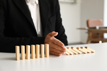 Female mediator separating blocks at table in office, closeup