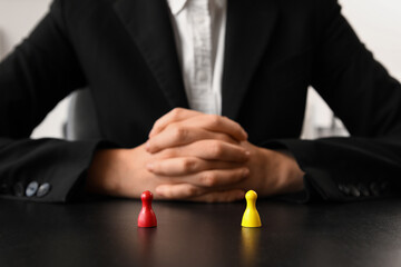 Female mediator with figures at table in office, closeup