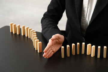 Female mediator separating wooden blocks on table in office, closeup